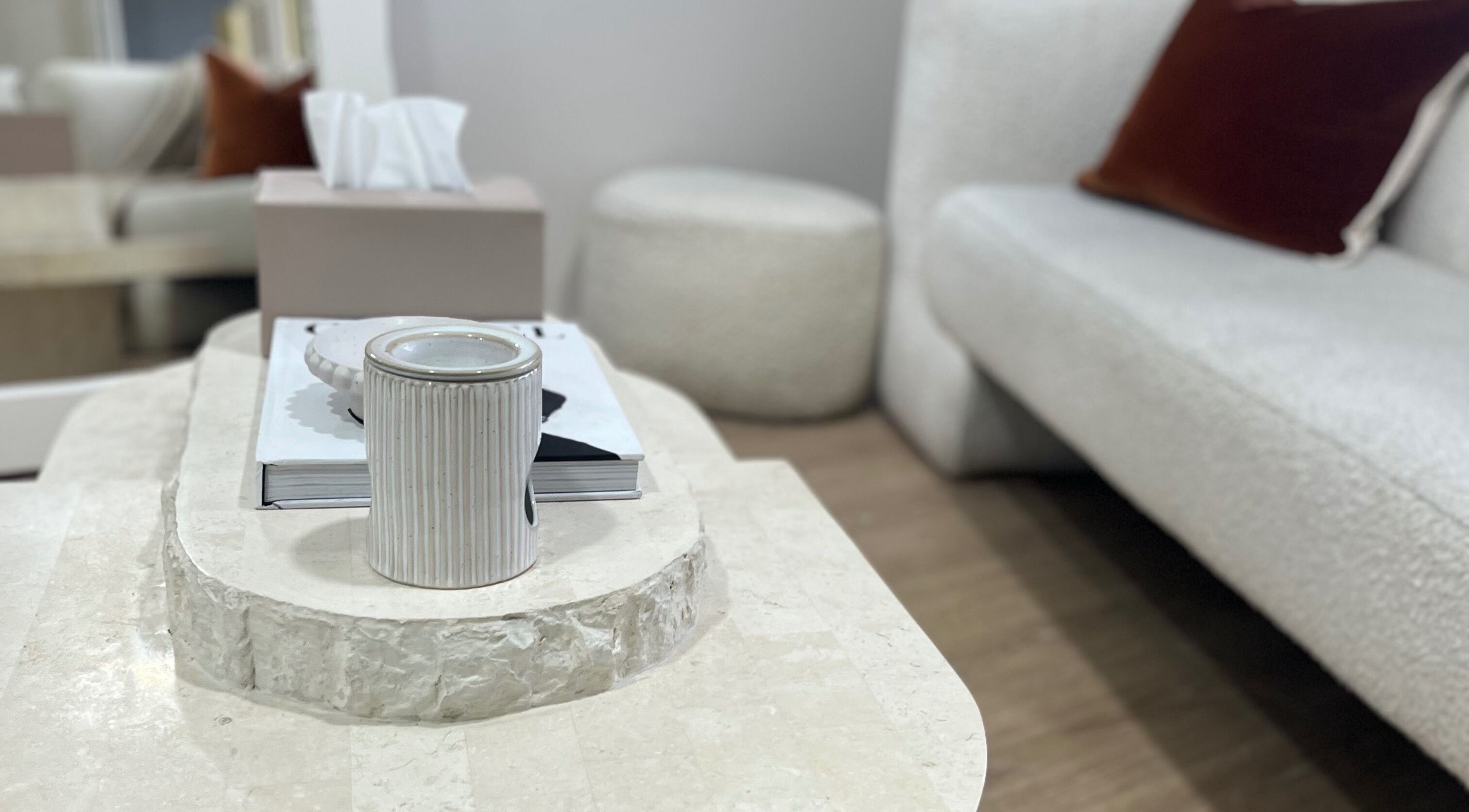 Cozy seating area at Facial Skin Specialist, Smithfield 2164, New South Wales, AU, featuring a stone table and sofas.