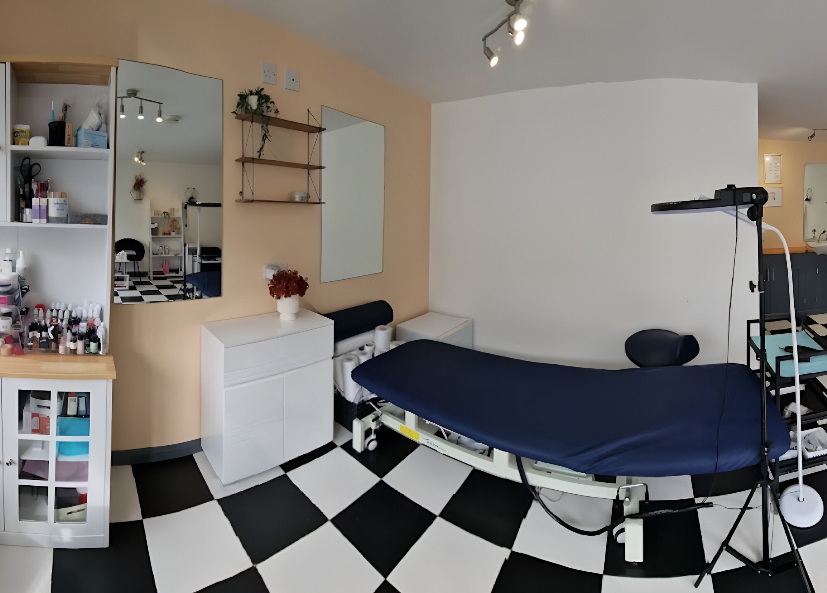 Tania Bhangoo Permanent Makeup studio interior in Cambridge, England, GB featuring treatment bed and supplies.