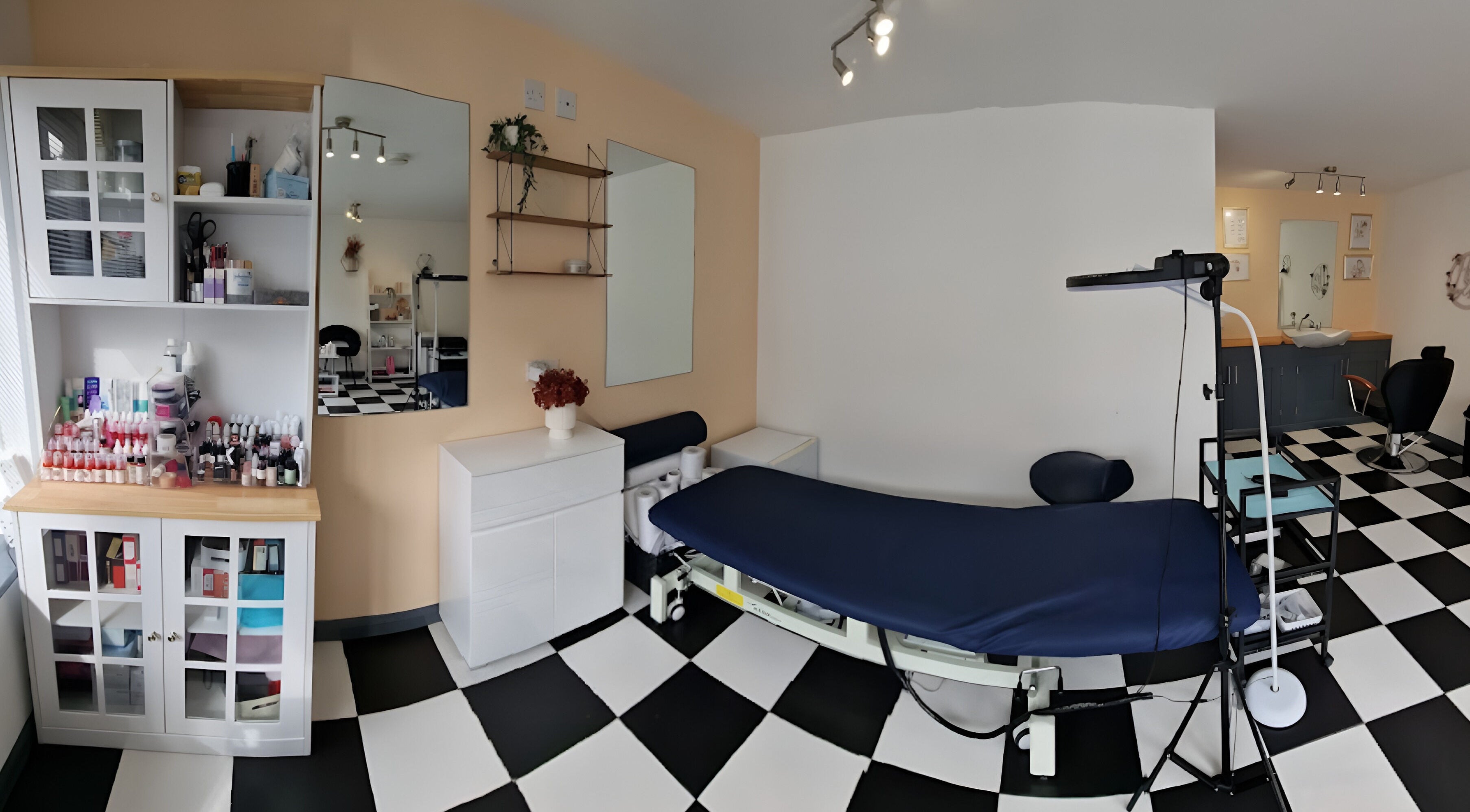 Tania Bhangoo Permanent Makeup studio interior in Cambridge, England, GB featuring treatment bed and supplies.