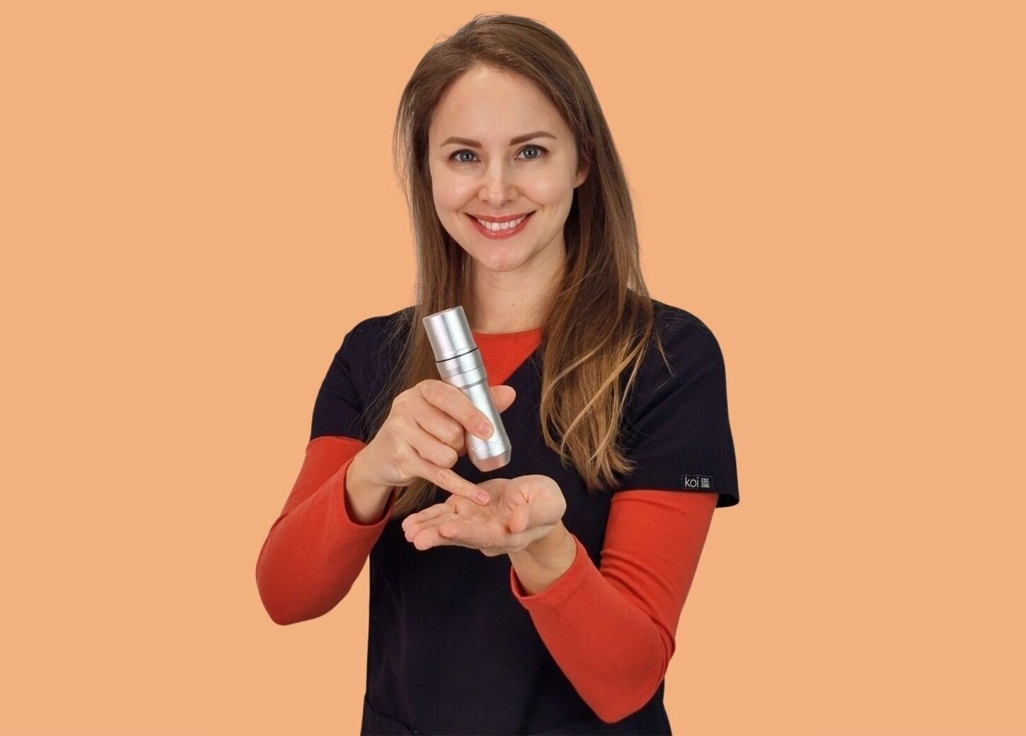 Smiling person holding skincare product at Tania Bhangoo Permanent Makeup, Cambridge, England, GB.
