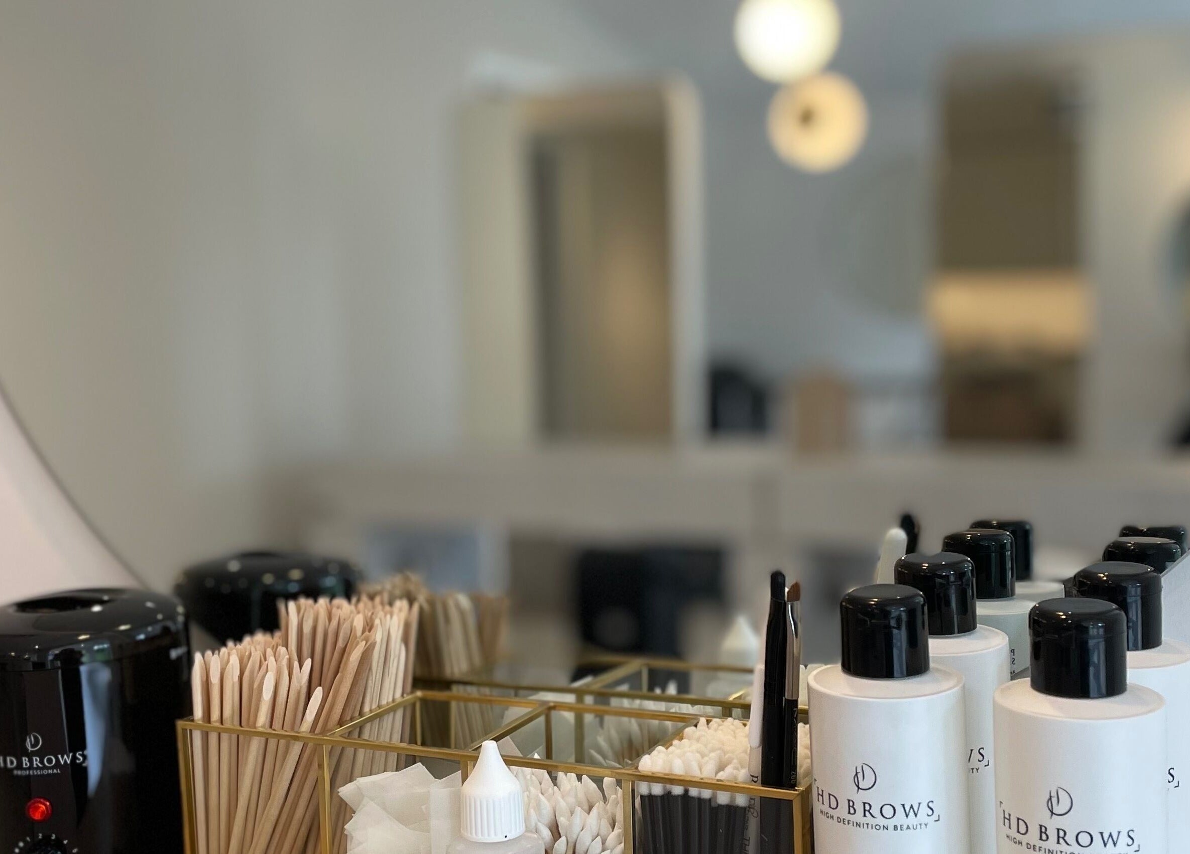 Mirror view of beauty products at Jessica Simpson Studio, Tonbridge, England, GB, showcasing elegant ambiance.