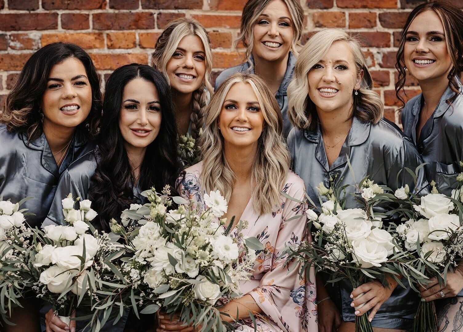 Bridal party with flowers at Jessica Simpson Studio, Tonbridge, England, GB. Celebrating beauty and wellness.