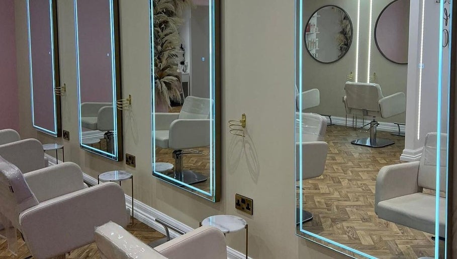 Elegant salon interior at House of GC Salon, Leslie, Scotland, GB, featuring illuminated mirrors and modern chairs.