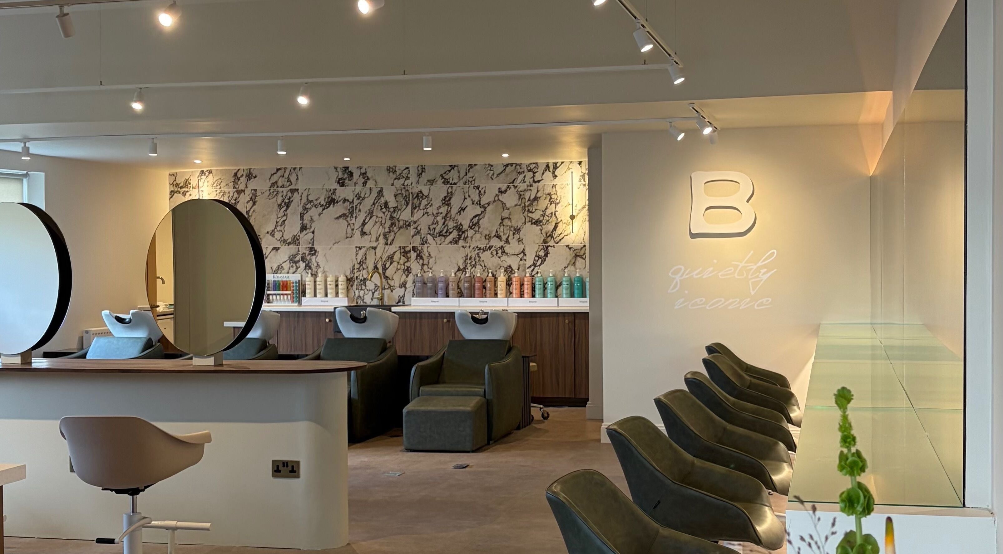 Elegant interior of Bissett Salon in Glenrothes, Scotland, GB with modern decor and comfortable seating.