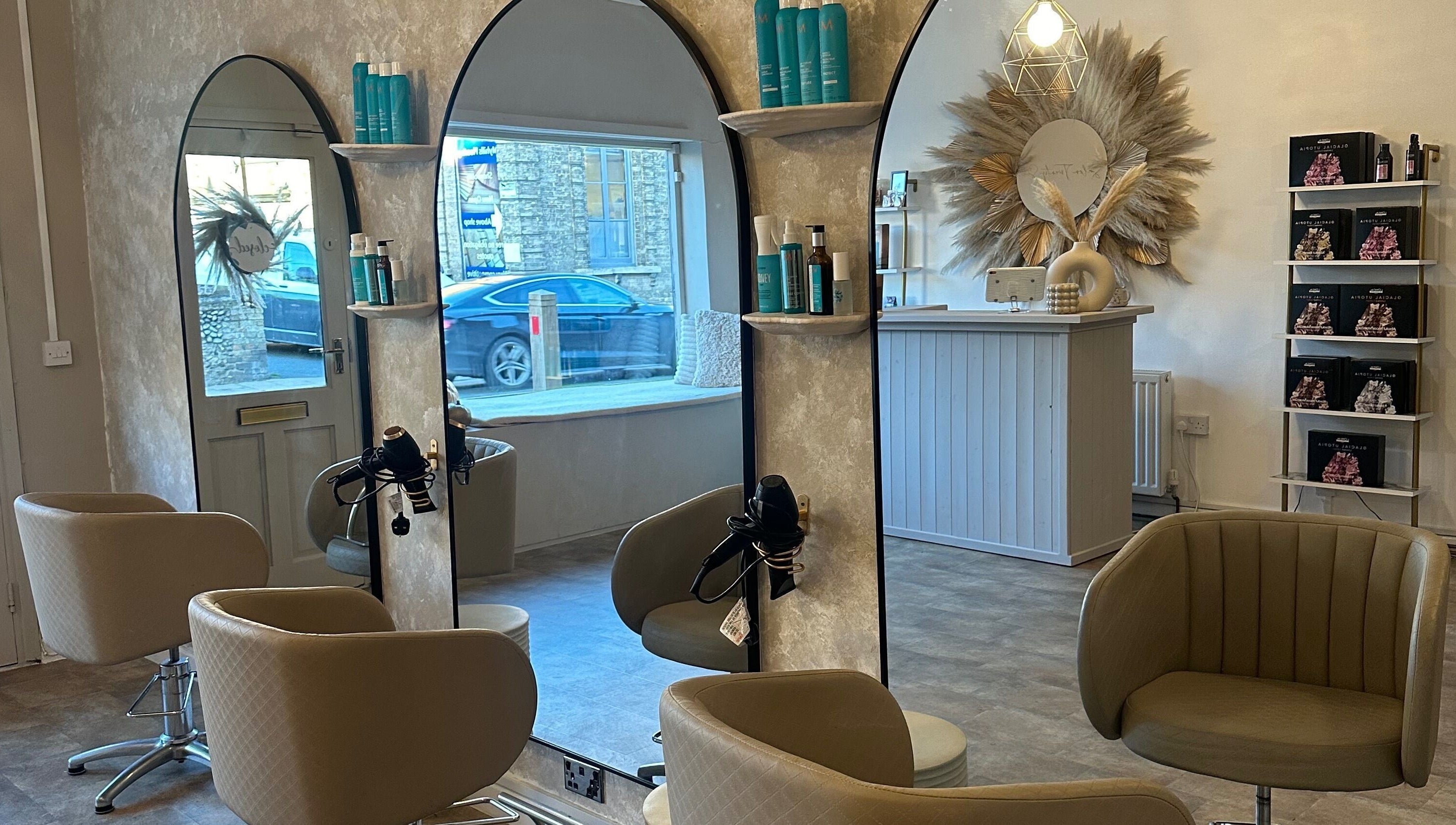 Elegant interior of Salon Twenty Six, Attleborough, England, featuring stylish mirrors and comfortable seating.