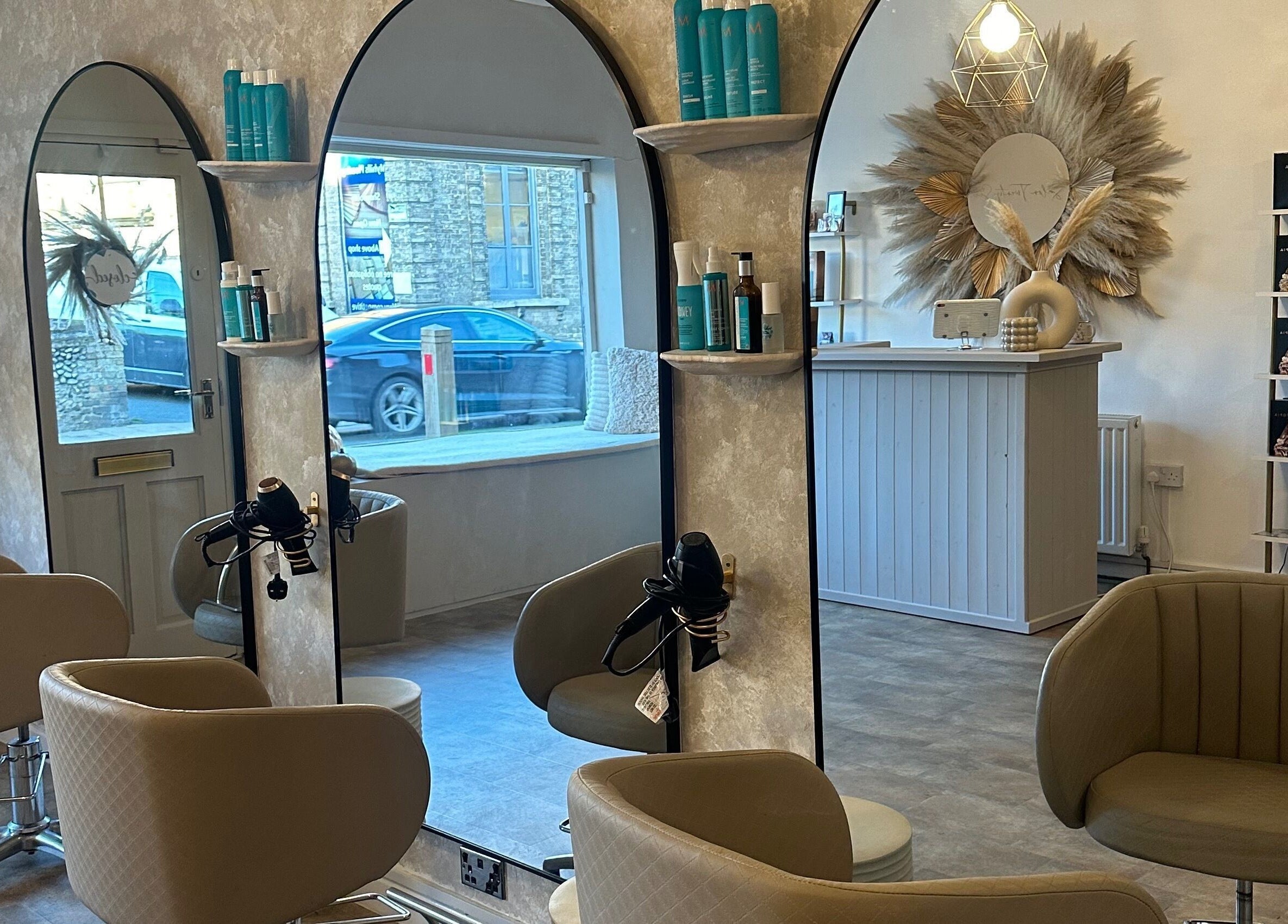Elegant interior of Salon Twenty Six, Attleborough, England, featuring stylish mirrors and comfortable seating.