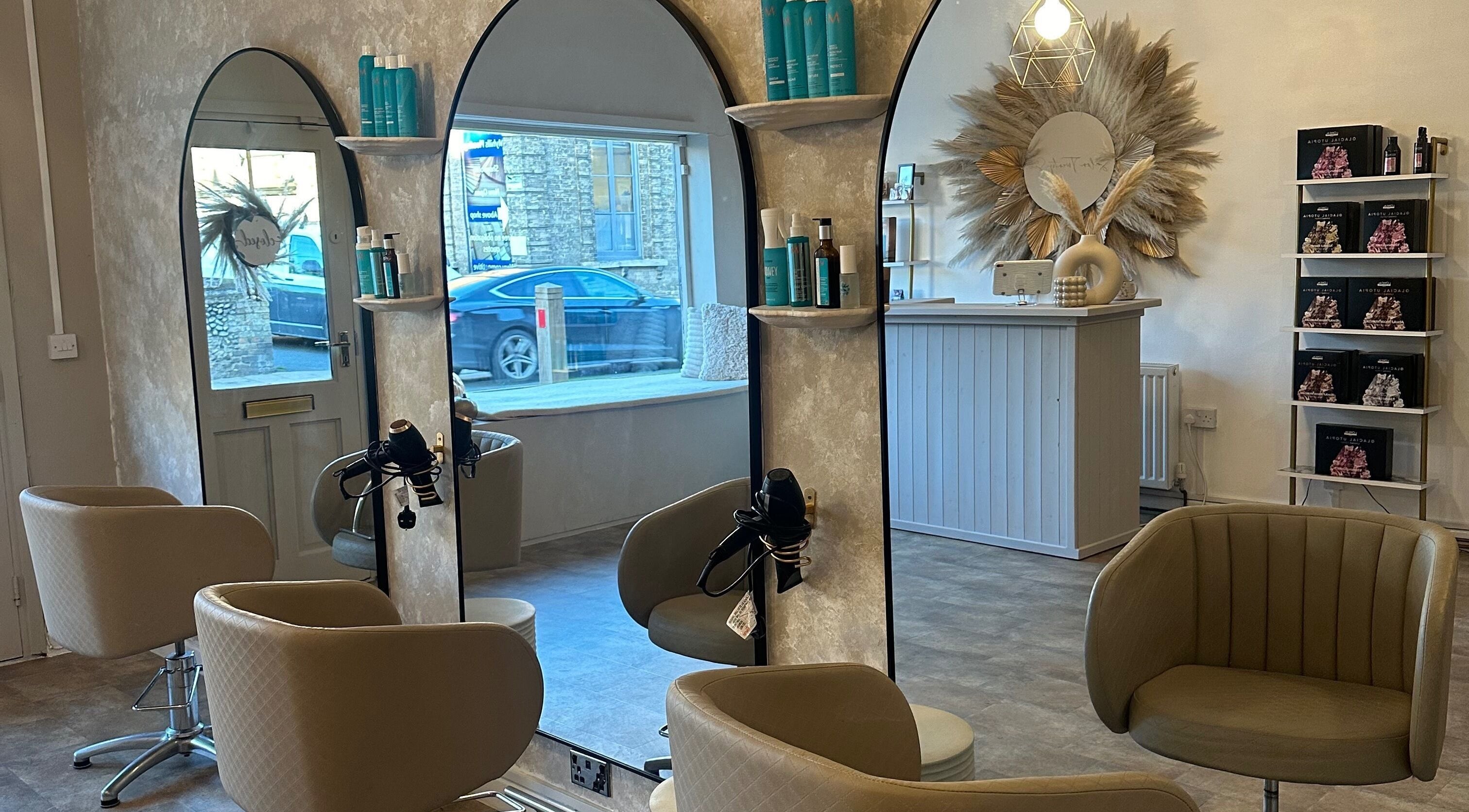 Elegant interior of Salon Twenty Six, Attleborough, England, featuring stylish mirrors and comfortable seating.