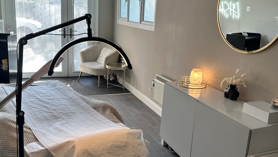 Calming treatment room at LH Skin Clinic, Birmingham, England, GB with cozy chair and ambient lighting.