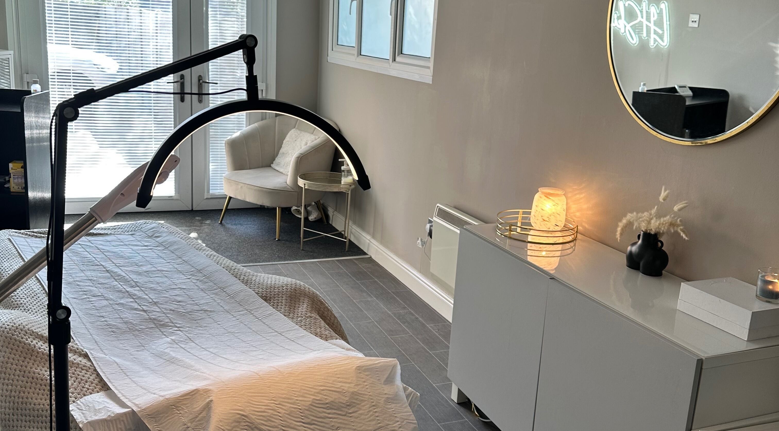 Calming treatment room at LH Skin Clinic, Birmingham, England, GB with cozy chair and ambient lighting.