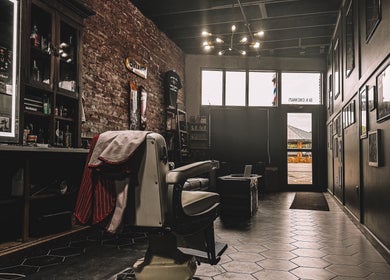 A classic barber chair at 46 Barber Society, Sperry, Oklahoma, US, exuding a vintage rustic charm.
