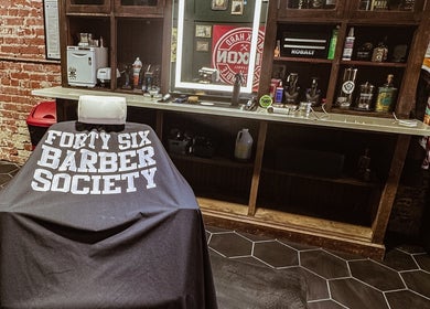 Interior of 46 Barber Society, Sperry, Oklahoma, showing a vintage barber chair and rustic decor.