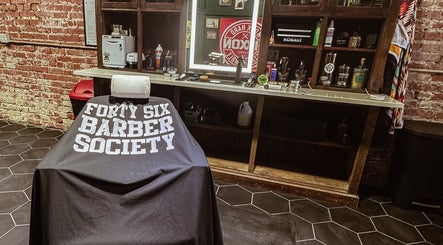 Interior of 46 Barber Society, Sperry, Oklahoma, showing a vintage barber chair and rustic decor.