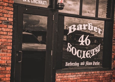 Exterior of 46 Barber Society in Sperry, Oklahoma featuring classic signage and brick facade.