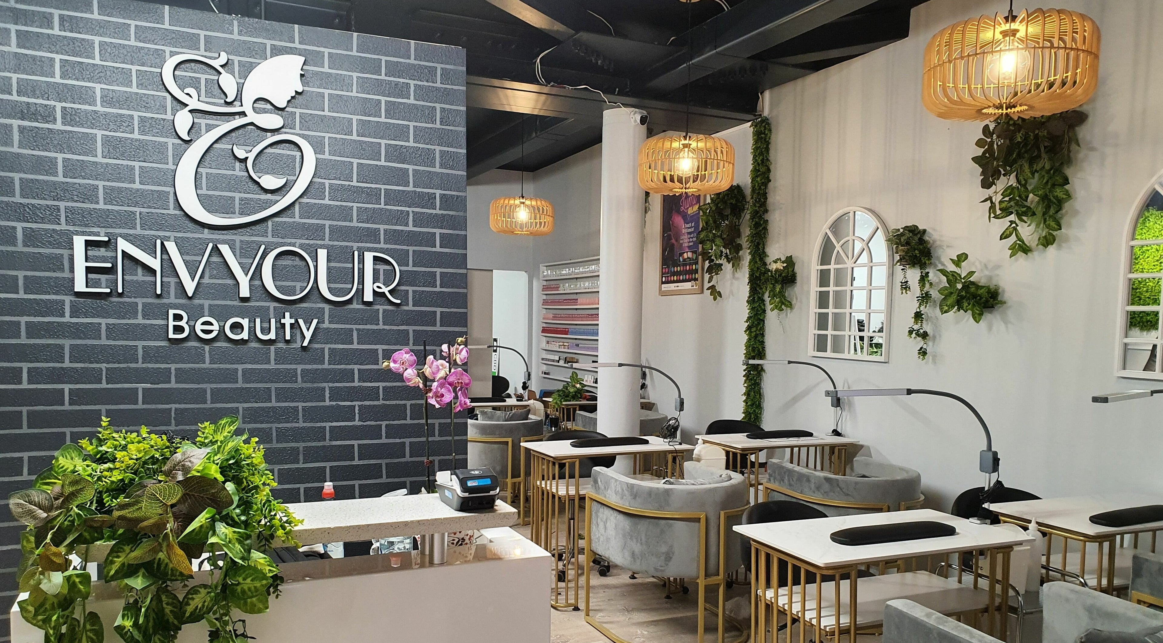 Modern interior of Envyour Beauty salon, Wellington, NZ, featuring chic decor and lush greenery.