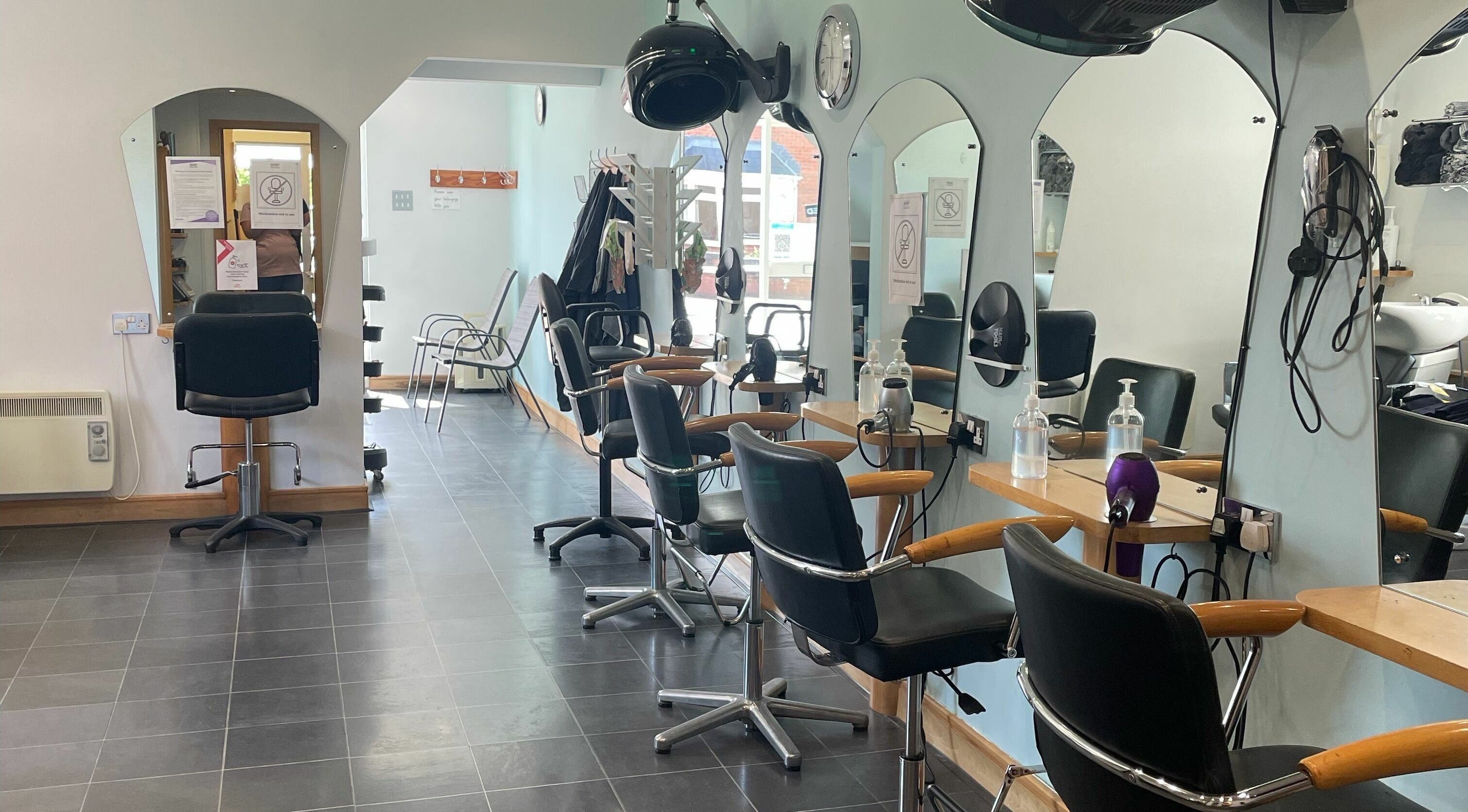 Modern salon setup at Gingers Hair Salon, Malvern, England, GB with sleek chairs and mirrors.