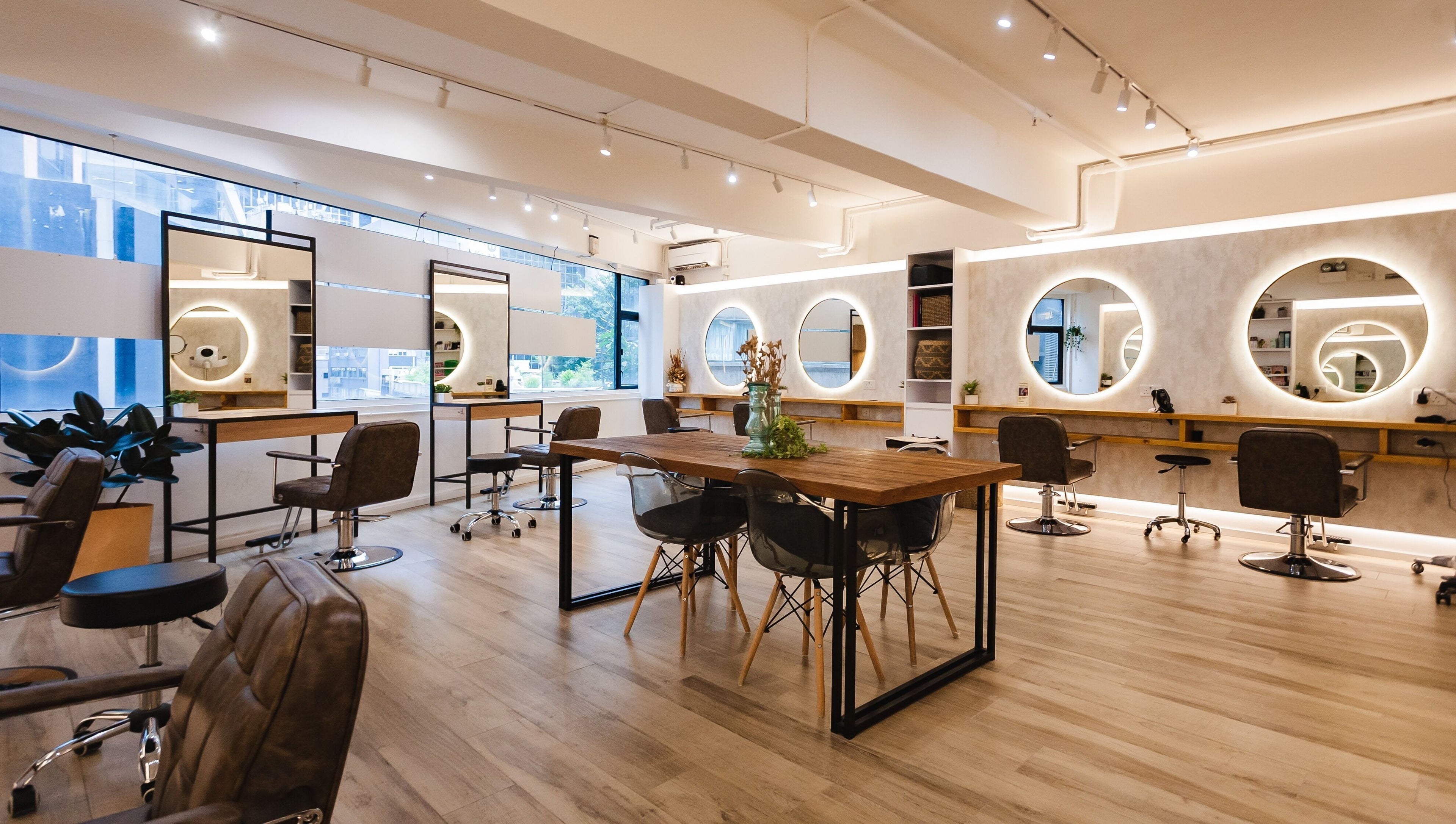 Modern interior at Sozo Hair Design on Hong Kong Island, HK, featuring chic salon chairs and mirrors.