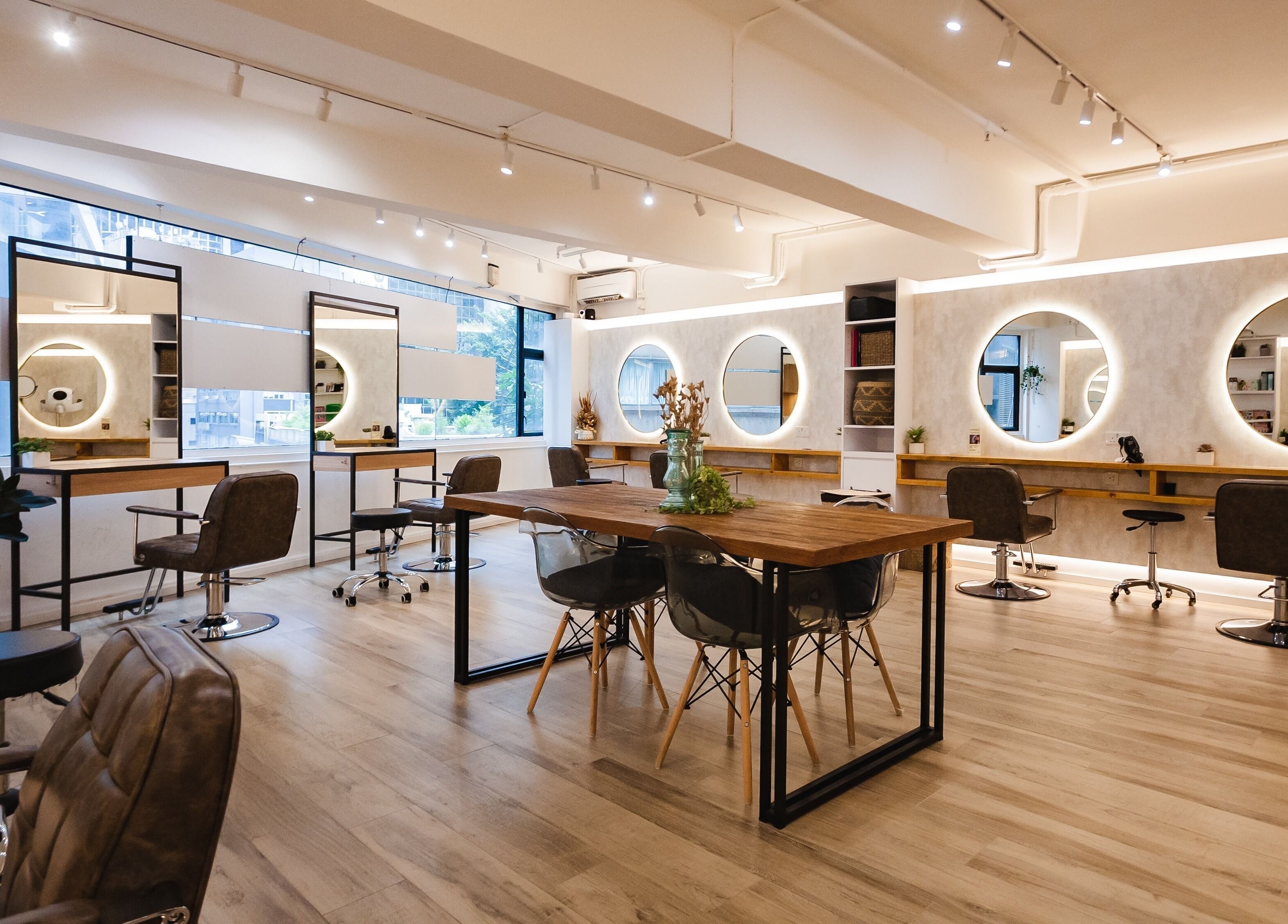 Modern interior at Sozo Hair Design on Hong Kong Island, HK, featuring chic salon chairs and mirrors.