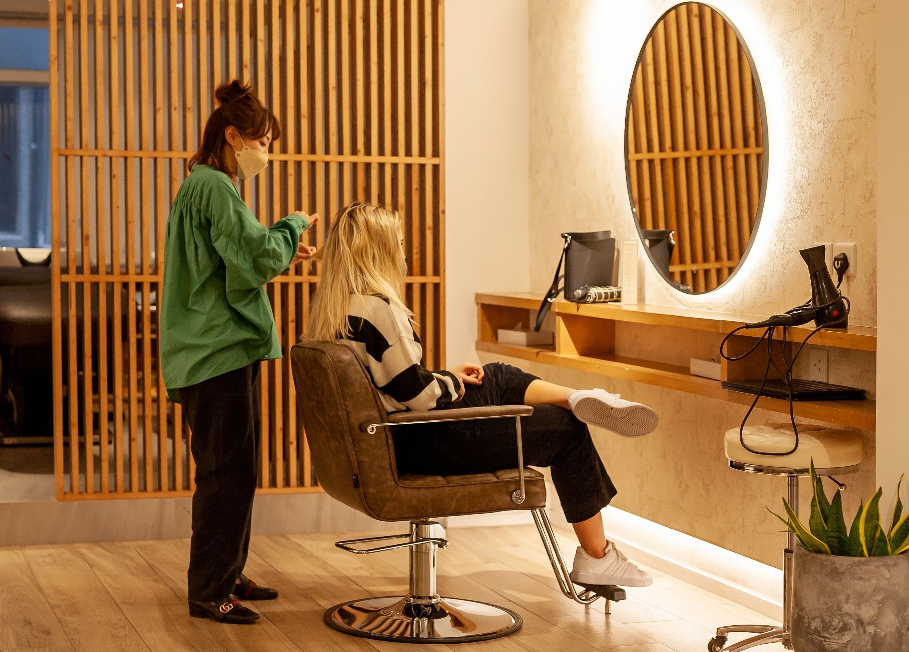Stylist working in Sozo Hair Design at Hong Kong Island, Hong Kong Island, HK. Modern salon decor and ambiance.