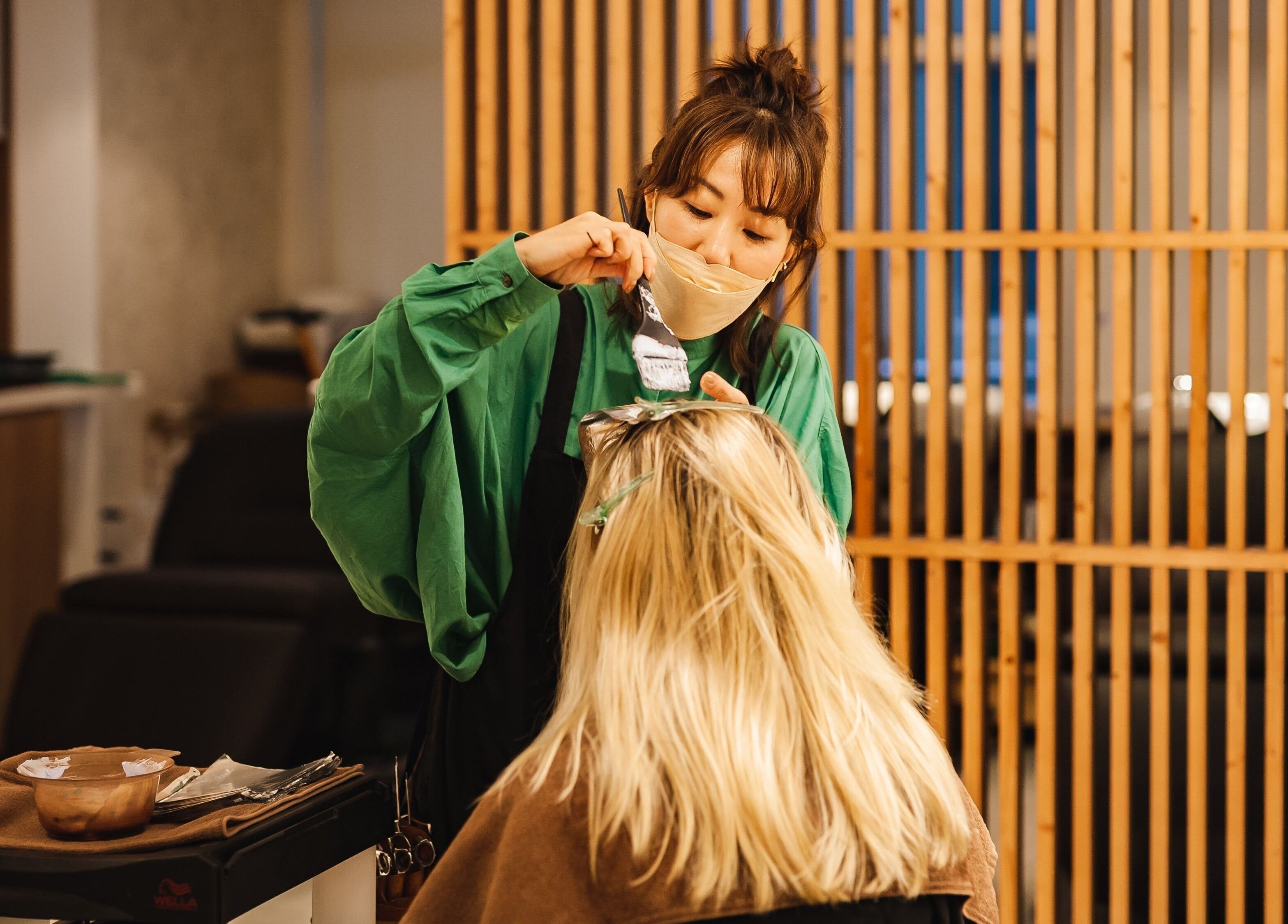 Expert colorist at Sozo Hair Design, Hong Kong Island, applying hair dye with precision.