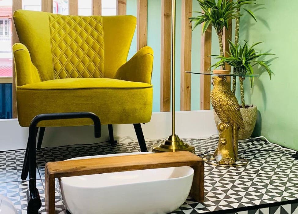 Cozy pedicure chair at Pink Ivy, Στρόβολος, Λευκωσία, CY, with a decorative golden eagle and lush plants.