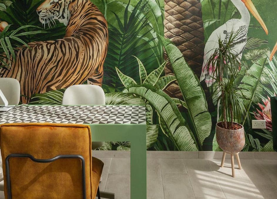 Vibrant tropical-themed interior at Pink Ivy, Στρόβολος, Λευκωσία, CY, featuring lush greenery and animal murals.