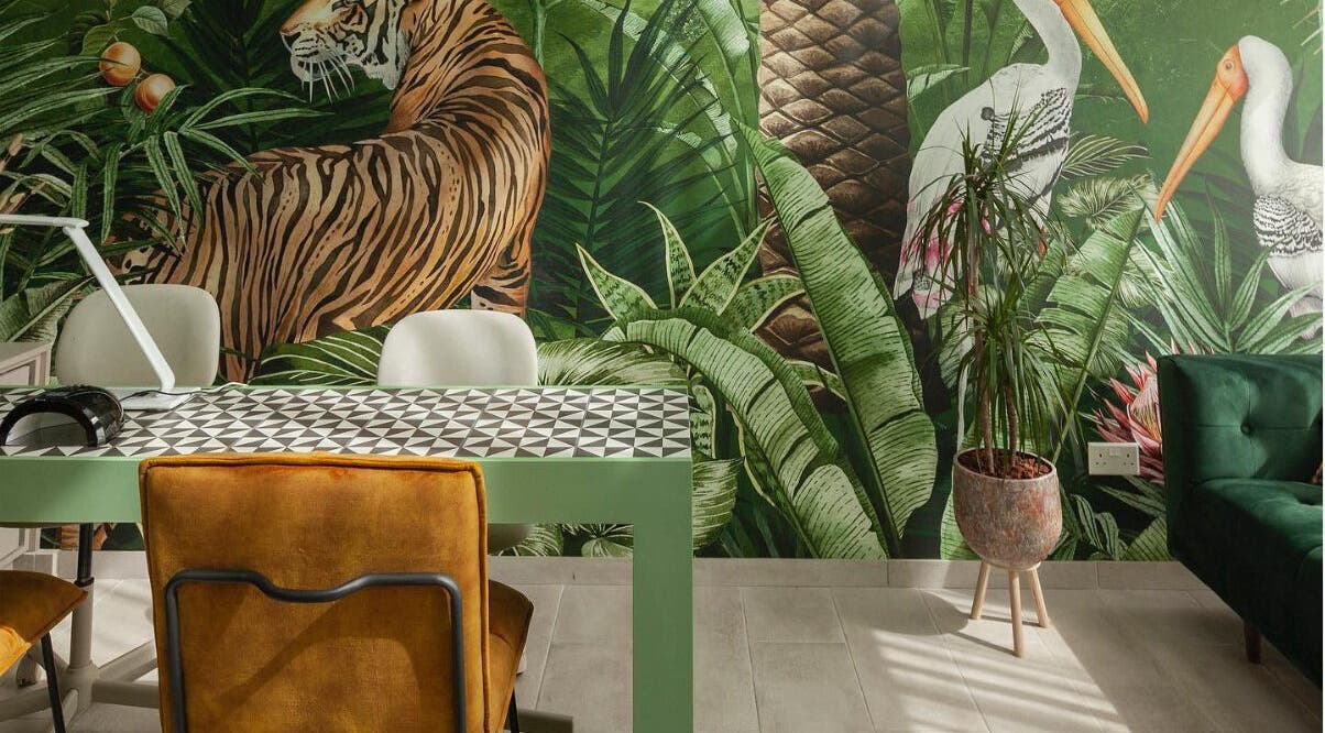 Vibrant tropical-themed interior at Pink Ivy, Στρόβολος, Λευκωσία, CY, featuring lush greenery and animal murals.