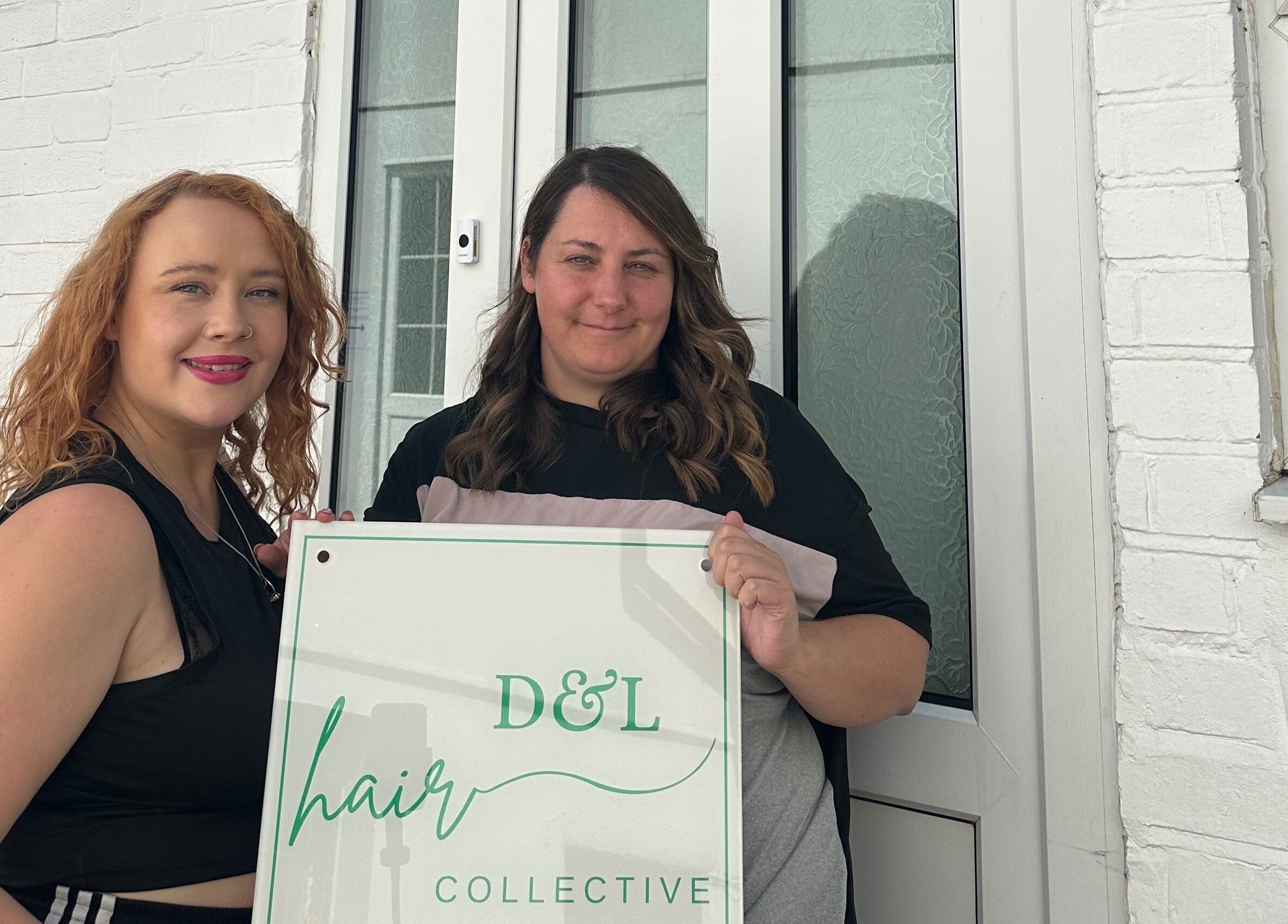 Stylists outside Science Behind Hairdressing, Wolverhampton, England, GB with salon sign.