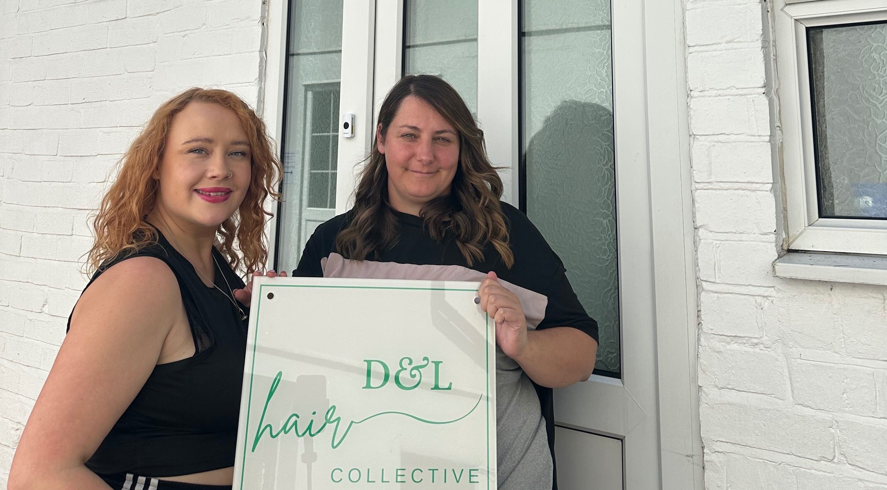 Stylists outside Science Behind Hairdressing, Wolverhampton, England, GB with salon sign.