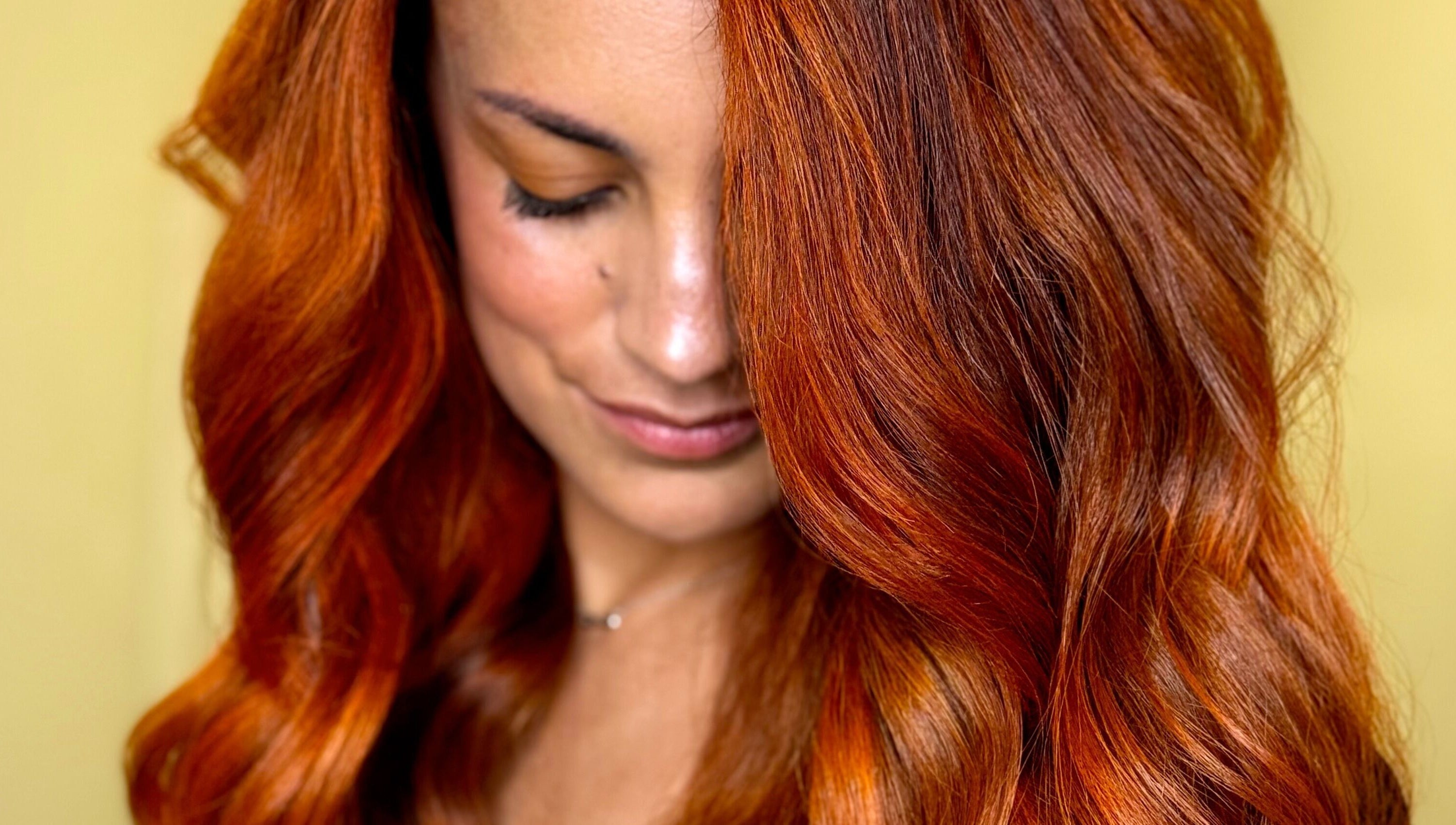 Vibrant red hair styled at New Style by Maye, Melbourne, Victoria, AU showcases expert coloring.