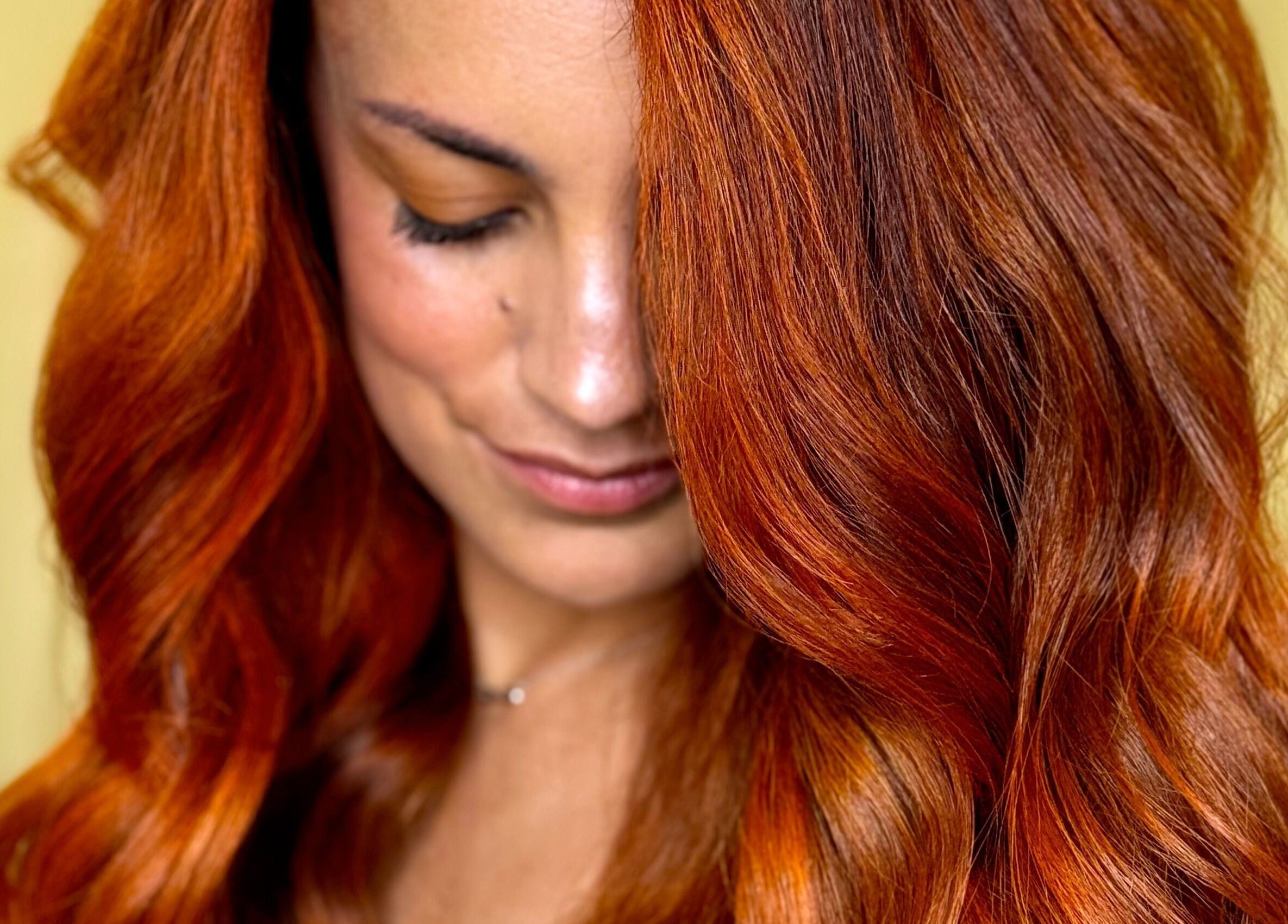 Vibrant red hair styled at New Style by Maye, Melbourne, Victoria, AU showcases expert coloring.