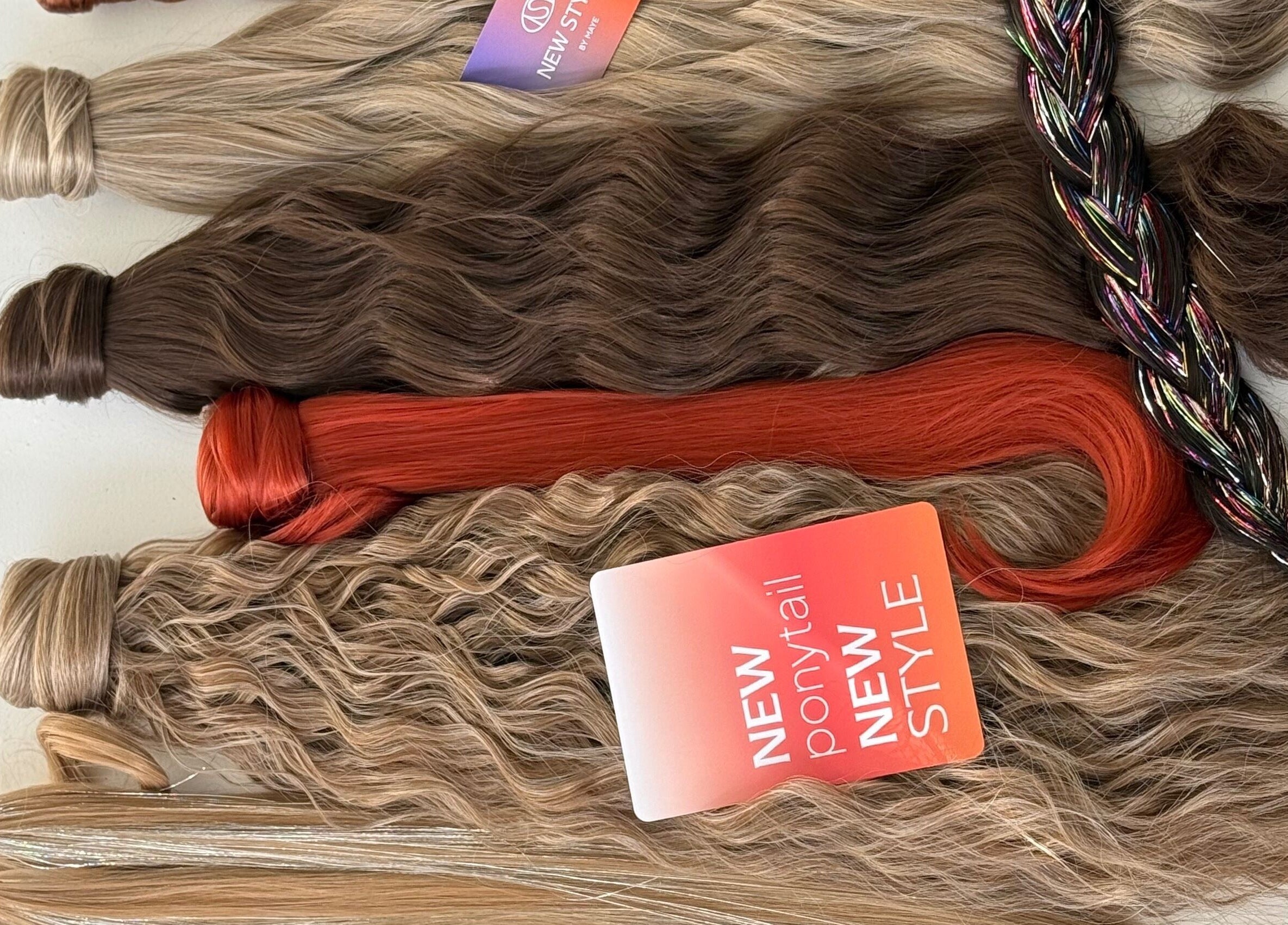 Colorful hair extensions at New Style by Maye, Melbourne, Victoria, AU, featuring varied shades and textures.