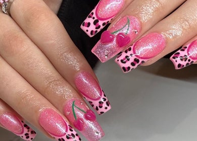 Vibrant pink nail art at Luxurious Studio, Richmond Hill, Ontario, CA, featuring cherry and leopard print designs.