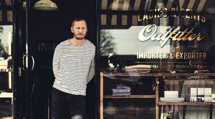 Exterior view of Milo’s stylish shopfront in Brighton, England, GB showcasing fashion garments.