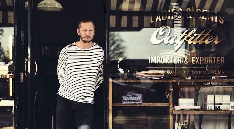 Exterior view of Milo’s stylish shopfront in Brighton, England, GB showcasing fashion garments.