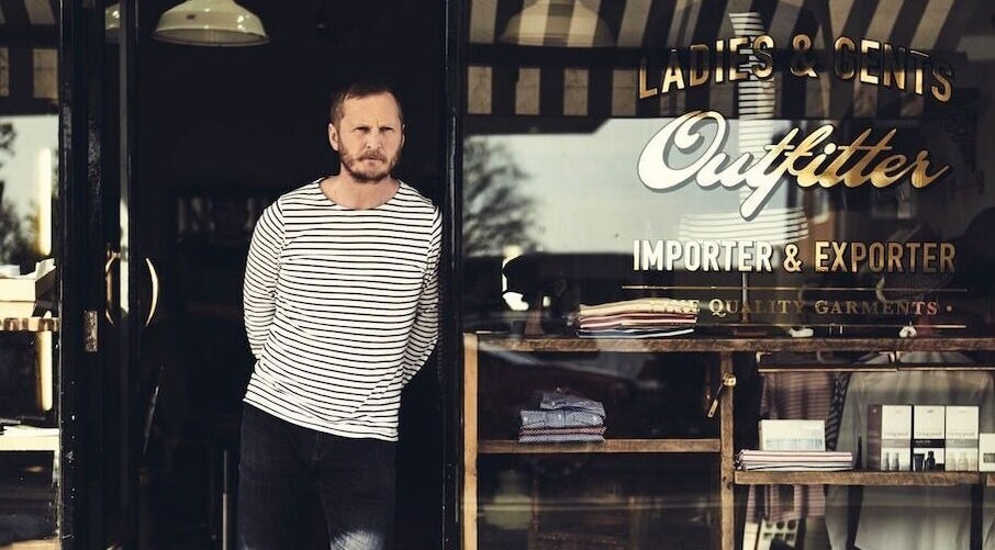 Exterior view of Milo’s stylish shopfront in Brighton, England, GB showcasing fashion garments.