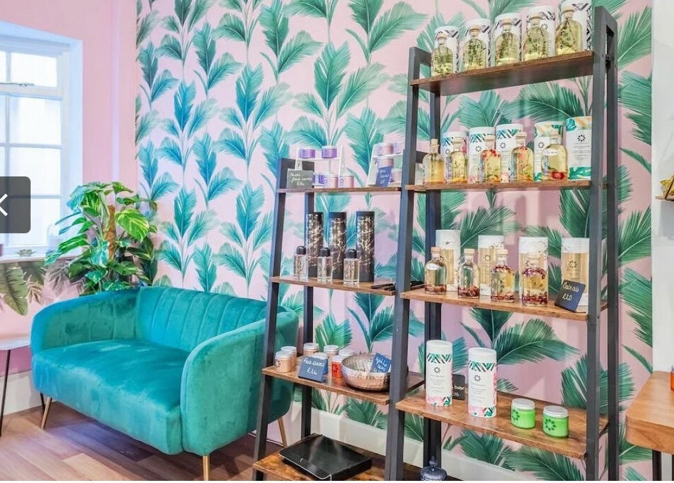 Relaxing seating area and product display at Aura Organics Spa - Greenwich, London, England, GB.