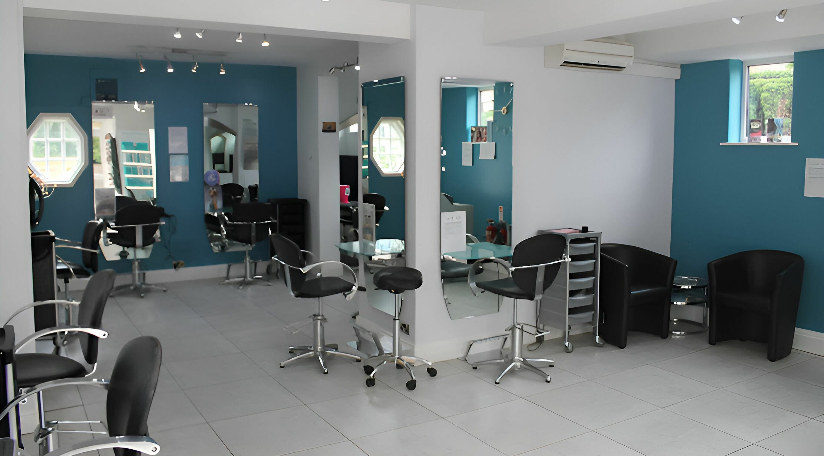Stylish interior of Haze Hair and Beauty salon in York, England, GB with modern chairs and mirrors.
