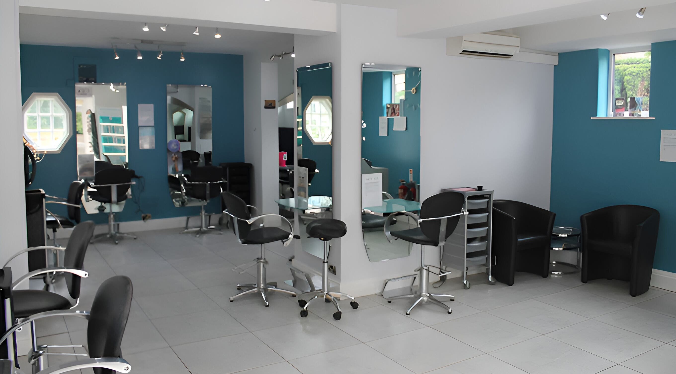 Modern salon interior of Haze Hair and Beauty in York, England, GB with stylish chairs and mirrors.