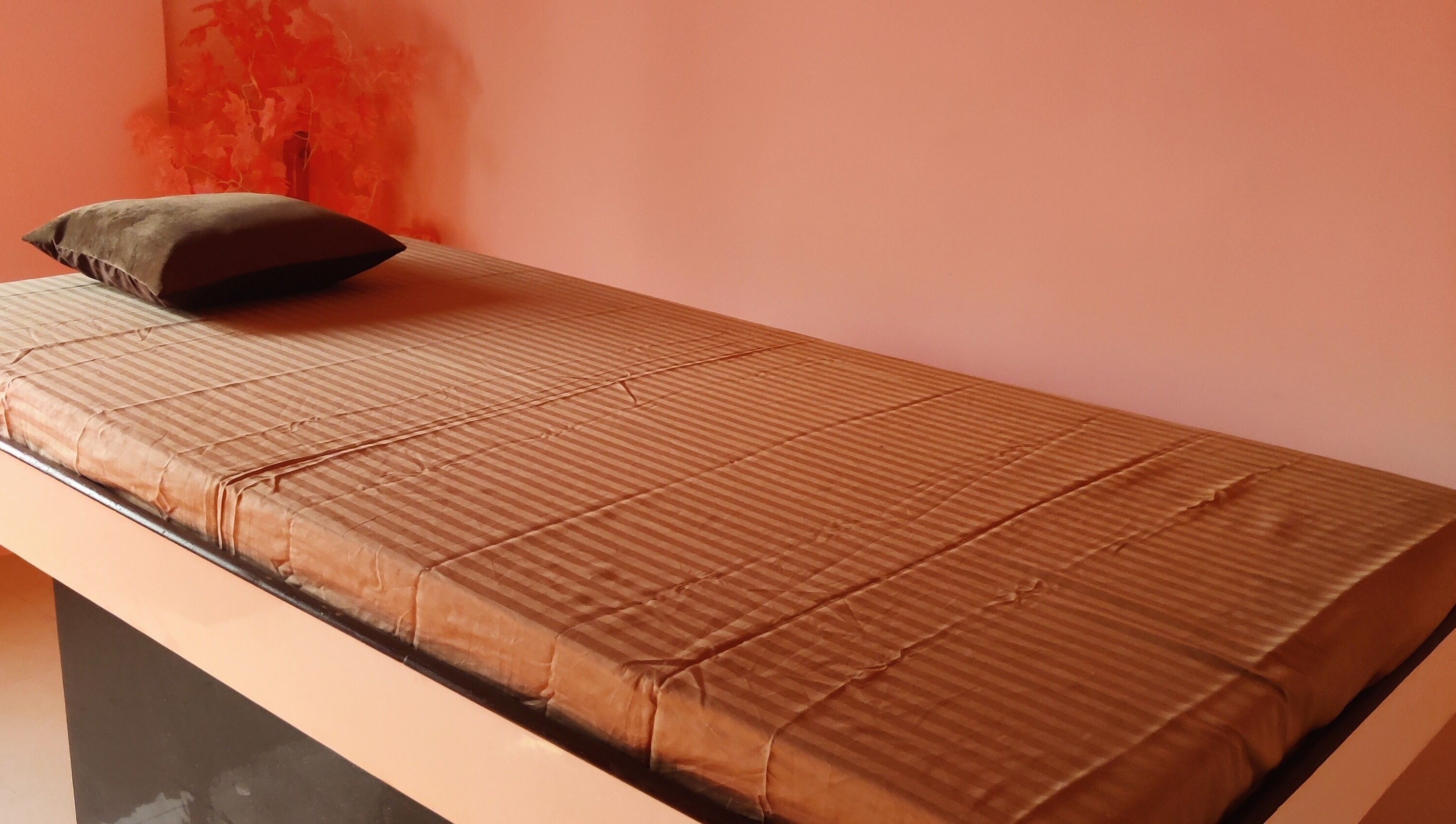 Massage bed with soft linen at Absolute Ace Unisex Spa and Salon in Raipur, Chhattisgarh, IN.