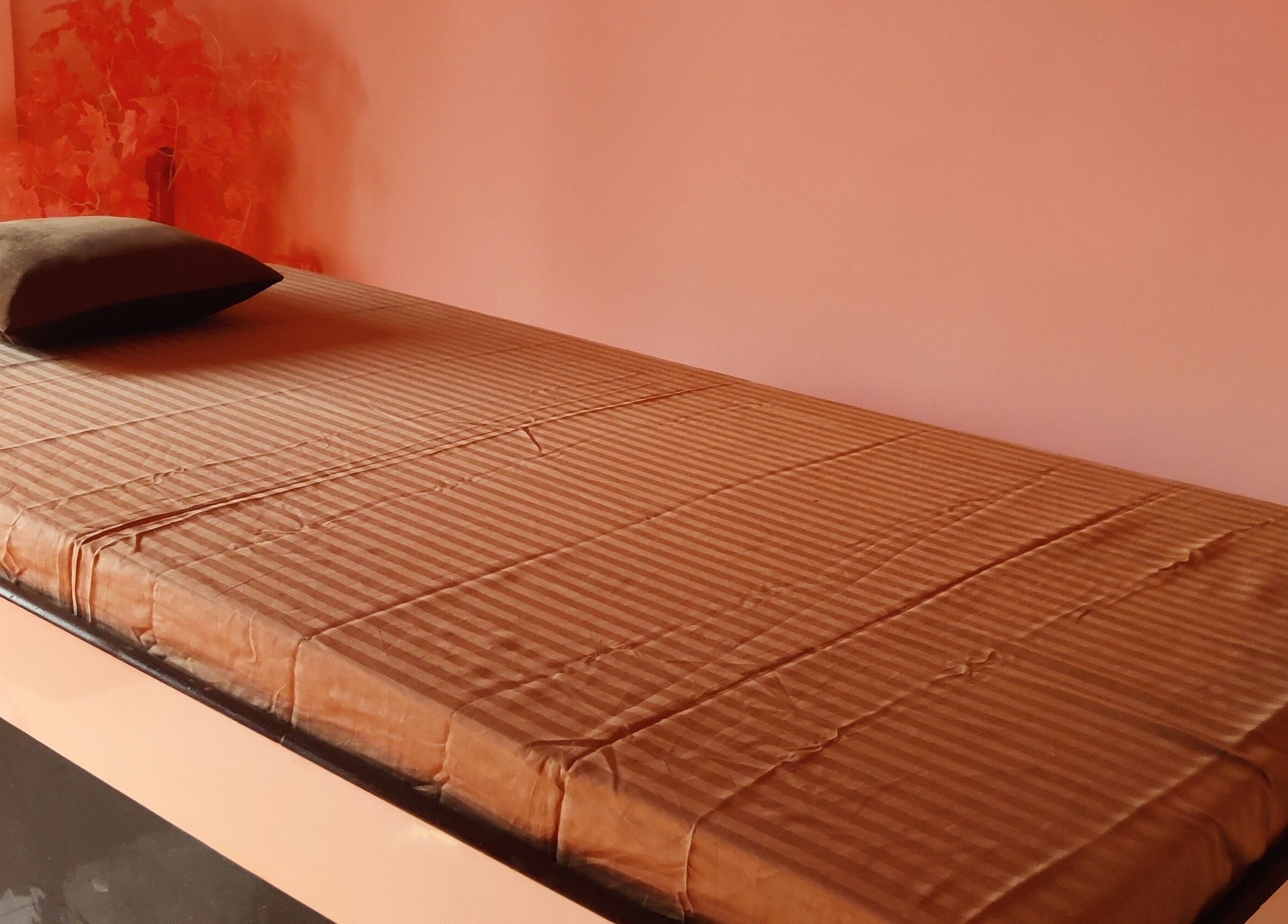 Massage bed with soft linen at Absolute Ace Unisex Spa and Salon in Raipur, Chhattisgarh, IN.