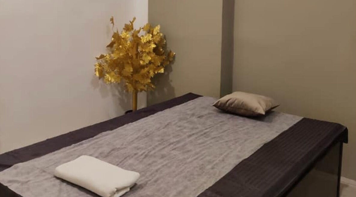 Tranquil spa room with a massage bed at Absolute Ace Unisex Spa and Salon, Raipur, Chhattisgarh, IN.