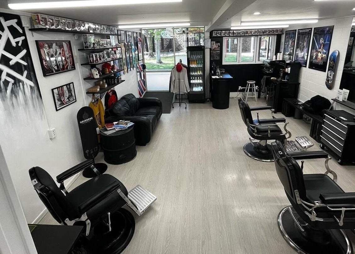 Interior of Three Diamonds Barbershop in Cromwell, Otago, NZ, featuring stylish chairs and vintage decor.
