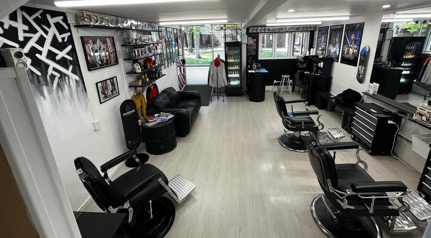Interior of Three Diamonds Barbershop in Cromwell, Otago, NZ, featuring stylish chairs and vintage decor.
