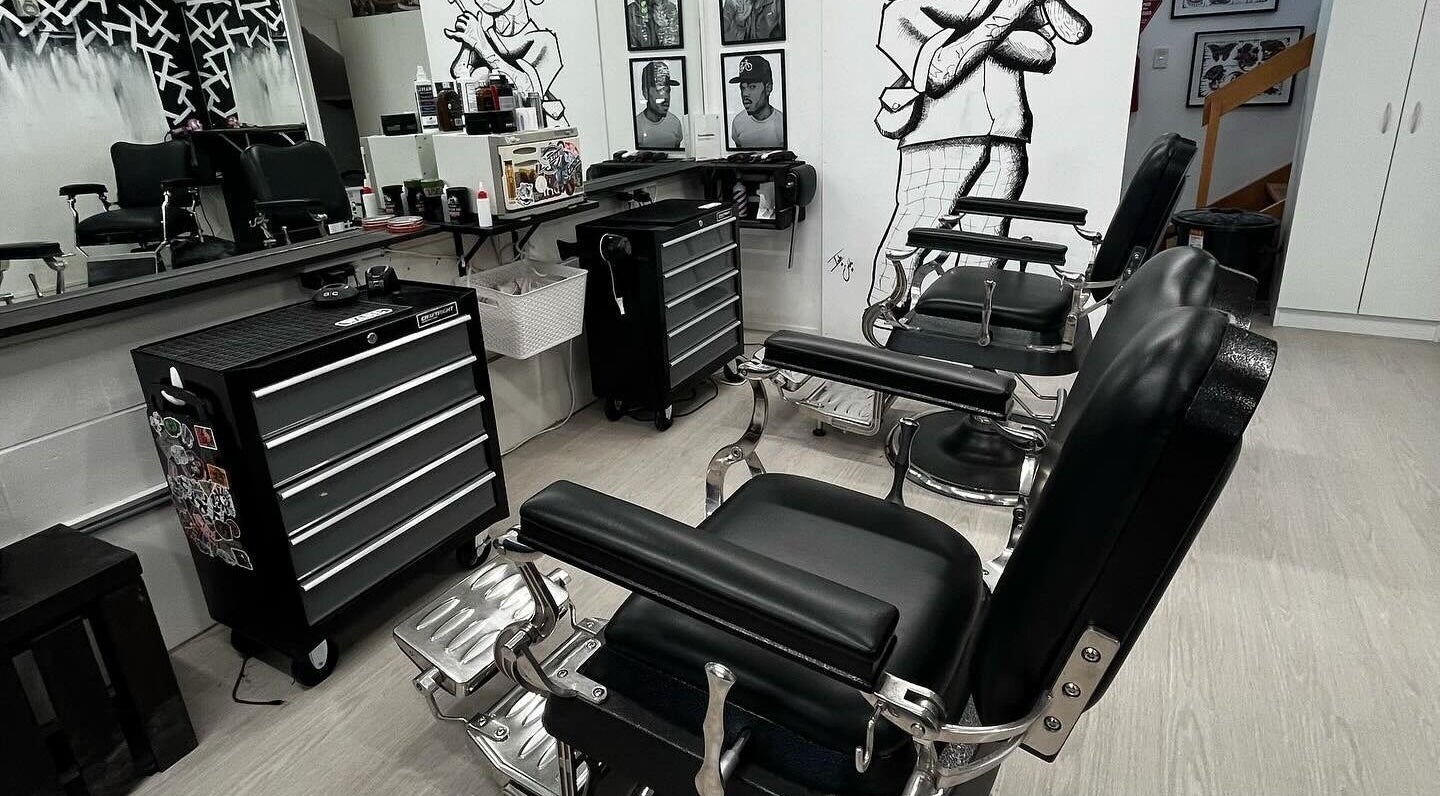 Modern barber chairs at Three Diamonds Barbershop, Cromwell, Otago, NZ, showcasing a sleek interior design.