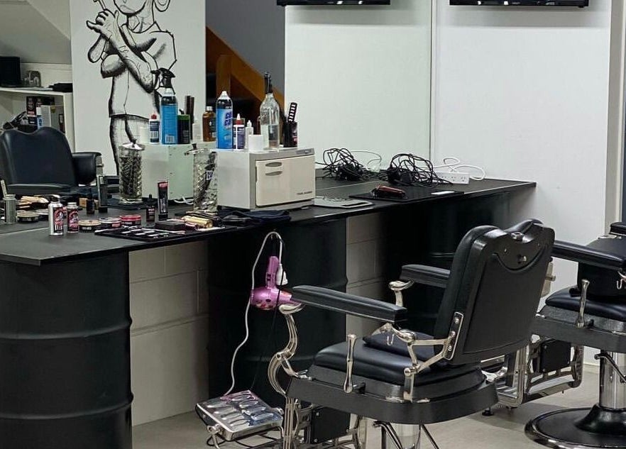 Interior of Three Diamonds Barbershop, Cromwell, Otago, NZ, featuring modern barber chairs and grooming tools.