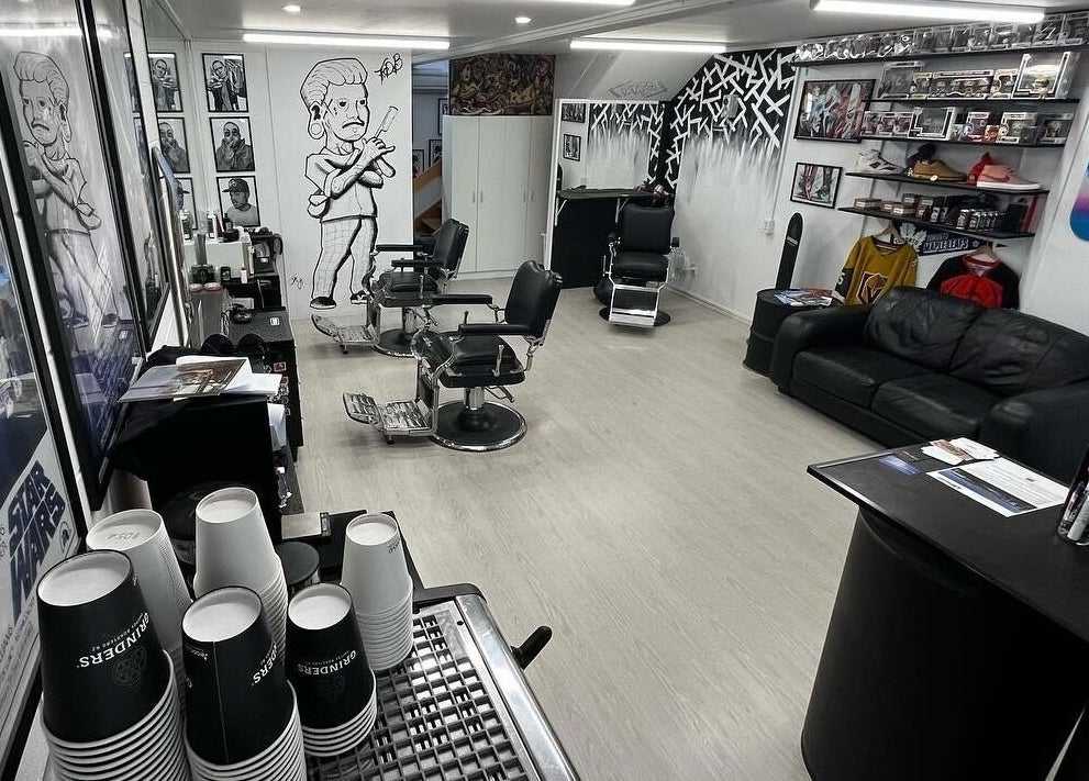Modern interior of Three Diamonds Barbershop in Cromwell, Otago, NZ, featuring retro-style decor and stylish chairs.