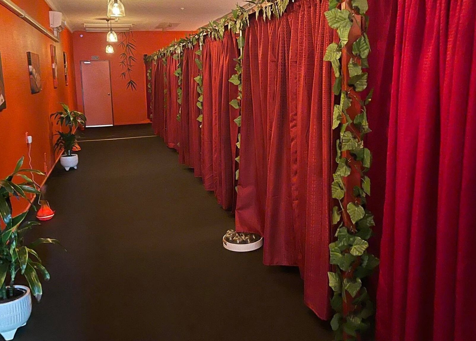 Bamboo Spa Lower Hutt Wellington corridor with red curtains and plants in Lower Hutt, Wellington, NZ.