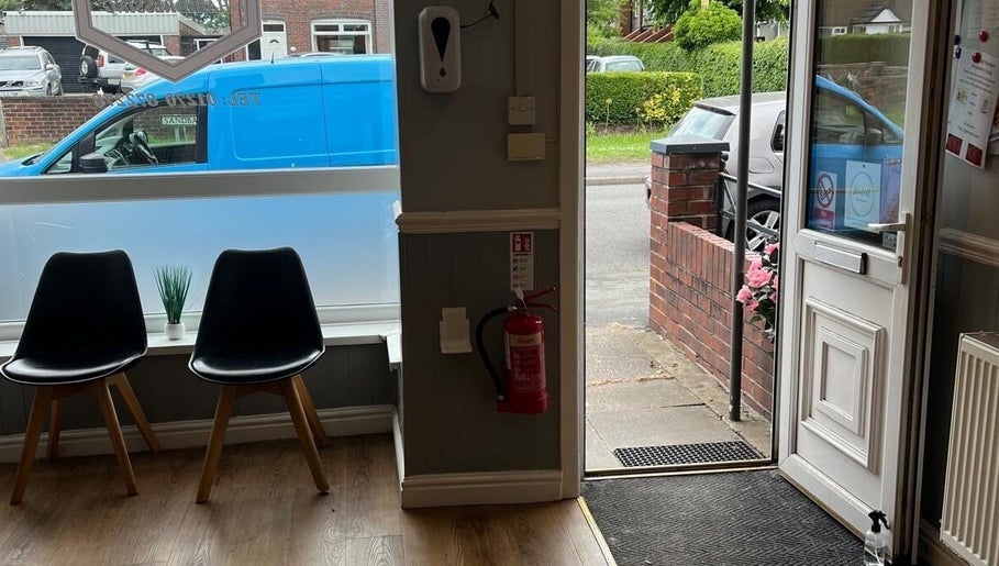 JB Hair entrance area with chairs and decor in Rode Heath, England, GB.