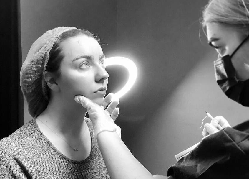 Beauty artist at ELR Cosmetics prepares a client for treatment in Liverpool, England, GB.