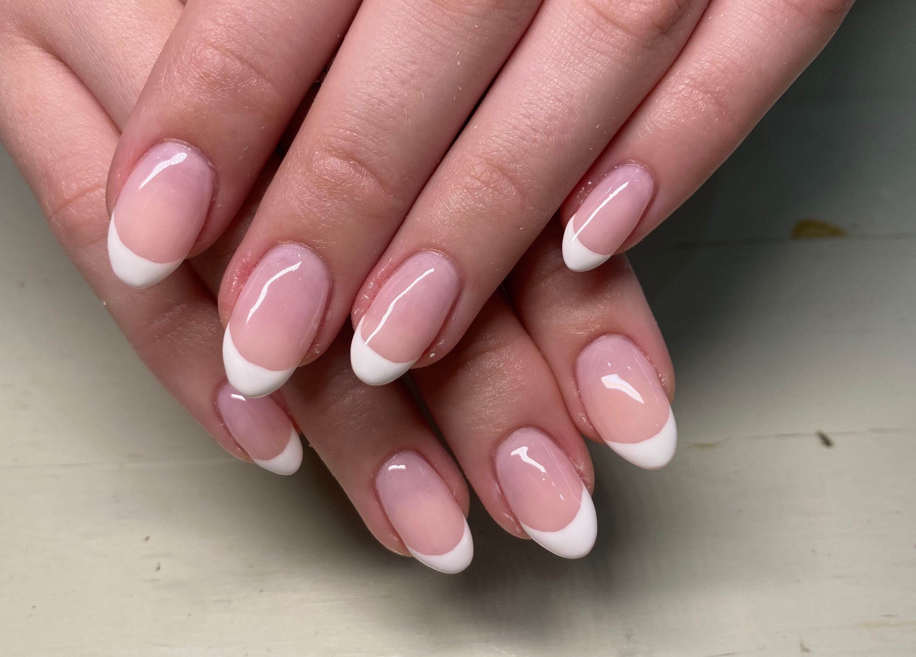 Elegant French manicure nails at Naked Nails, Pretoria, Gauteng, ZA showcasing glossy white tips.